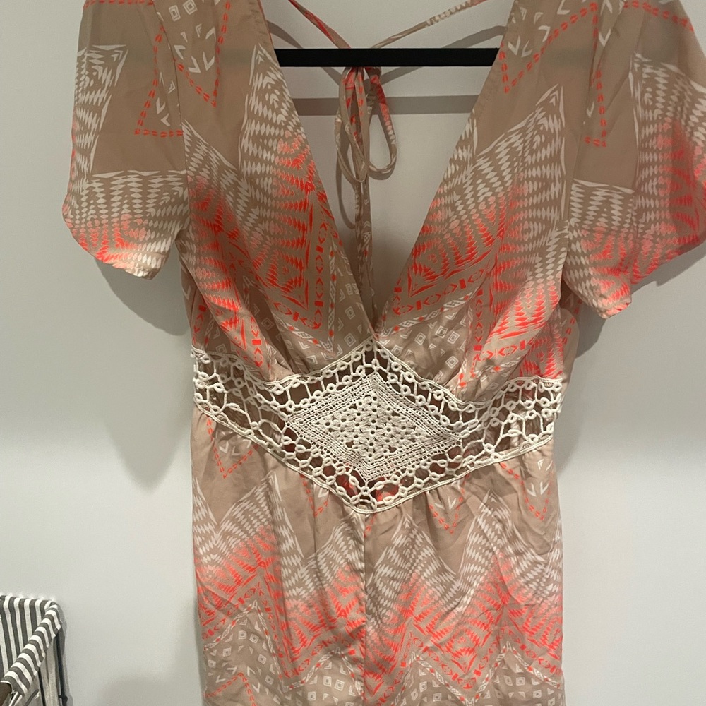 Romper cream and orange size small brand is Illa Illa
